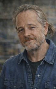 Staff headshot of Gary Duvall in a blue denim shirt.